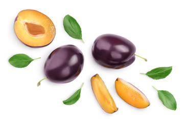 fresh purple plum and half with leaves isolated on white background with clipping path and full depth of field. Top view. Flat lay