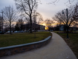 downtown park in small town American North East at sunset in late winter