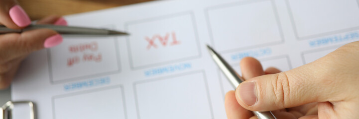 Focus on hands and pens of workers dealing with tax and audit. People thinking on financial difficulties of company. Man and woman calculating and accounting. Taxes and paying debts