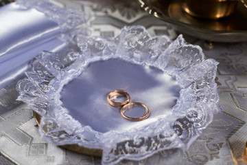 Wedding rings laid out on a plate in the Orthodox Church.