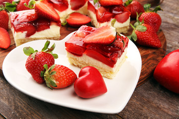 strawberry cake and many fresh strawberries on rustic table