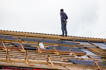 Roof worker during roof replacement