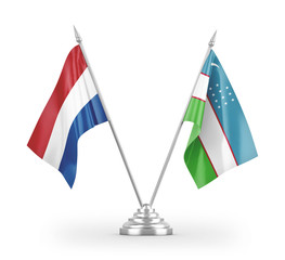 Uzbekistan and Netherlands table flags isolated on white 3D rendering