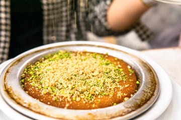 famous turkish desserts (kunefe) with cheese, walnut and pistachios