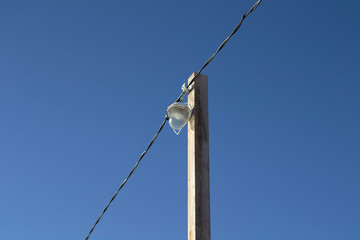 a lantern at a pedestrian crossing over a frozen river.