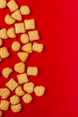 View from above to sweet mini cookies on the red background