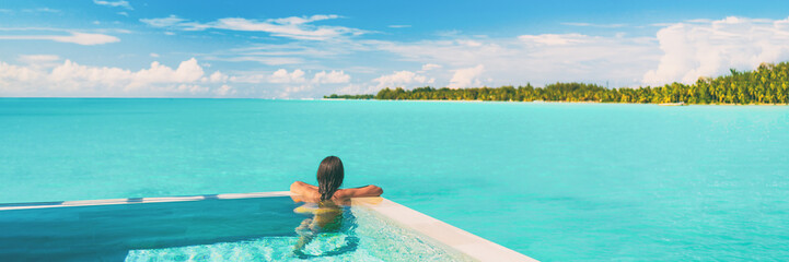 Luxury swimming pool resort paradise summer destination woman relaxing in infinity pool at hotel...