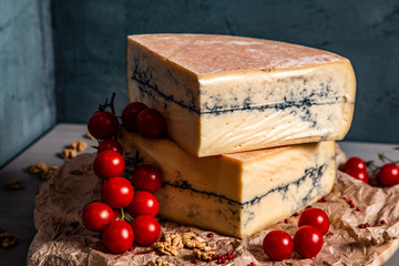 Garganzola cheese and cherry tomatoes on a blue background