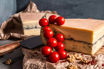 Garganzola cheese and cherry tomatoes on a blue background