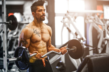 Fototapeta na wymiar Handsome Muscular Men Workout at the Gym