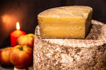 Big yellow goat cheese heads and fruit on a blue background.