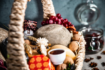 Basket with cheese, honey and grapes on a blue background
