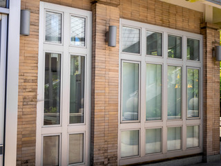 Glass  doors with turquoise frames at red bricked