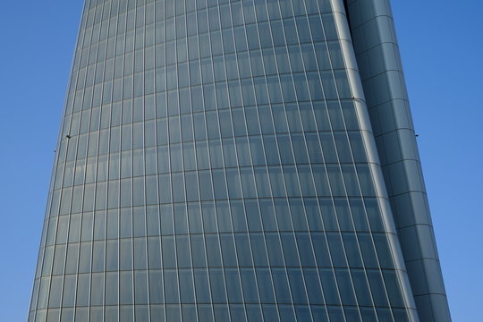 modern office building with reflection in windows of building
