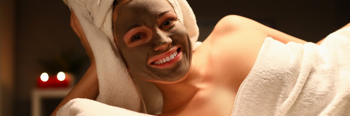 Beaty woman applied chocolate mask in spa salon facial portrait. Heath skin care concept. Look at...