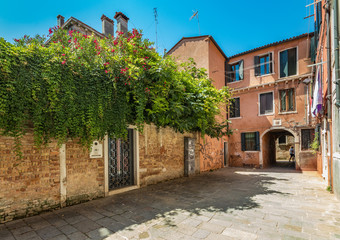 VENICE, ITALY - August 03, 2019: Narrow pedestrian streets of Venice bitween the channels. Some quiet places almost without people