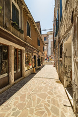 VENICE, ITALY - August 03, 2019: Narrow pedestrian streets of Venice bitween the channels. Some quiet places almost without people