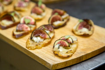 toast with brie cheese and figs on a wooden board