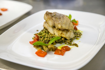 fish fillet on a bed of rice and tomato