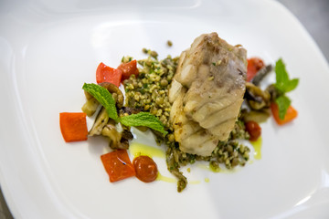 fish fillet on a bed of rice and tomato