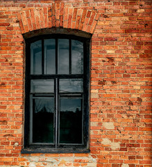 Window in a red-orange brick wall