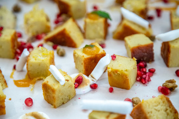 cake squares on a wooden board with chocolate and berries