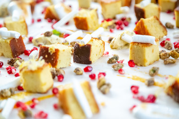 cake squares on a wooden board with chocolate and berries