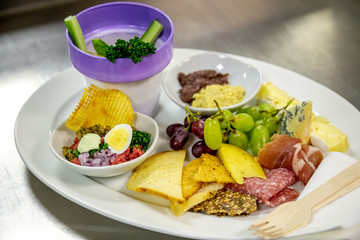 cheese and cold meat board with grapes and bread
