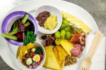 cheese and cold meat board with grapes and bread