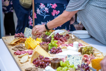 cheese and cold meat board with grapes and bread
