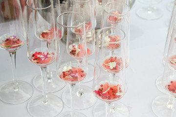 glasses with watermelon red peppercorns and flowers