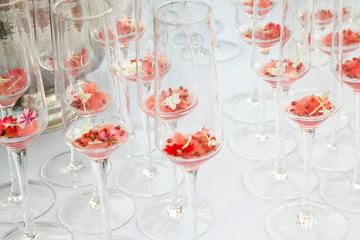 glasses with watermelon red peppercorns and flowers