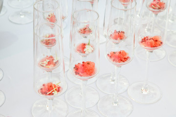 glasses with watermelon red peppercorns and flowers