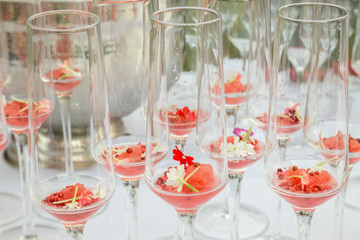 glasses with watermelon red peppercorns and flowers