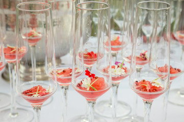 glasses with watermelon red peppercorns and flowers
