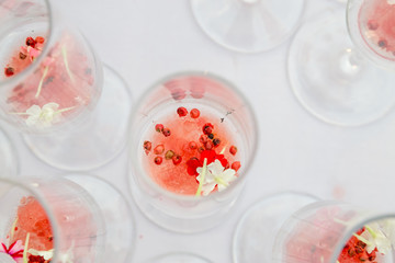 glasses with watermelon red peppercorns and flowers