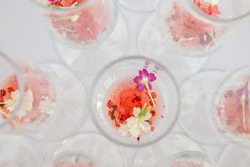 Fototapeta na wymiar glasses with watermelon red peppercorns and flowers