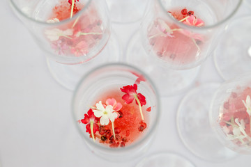 glasses with watermelon red peppercorns and flowers