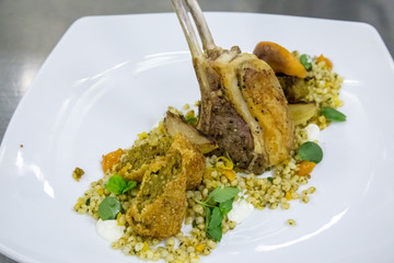 grilled lamb chop on a plate with rice and vegitables