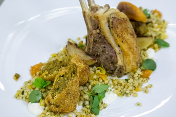 grilled lamb chop on a plate with rice and vegitables