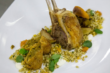 grilled lamb chop on a plate with rice and vegitables