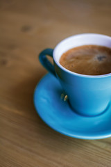 Cup of freshly made coffee in a blue and white ceramic cup.