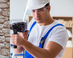 Repairman working with drilling drill perforator