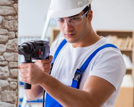 Repairman working with drilling drill perforator