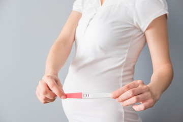 Pregnant woman showing positive test