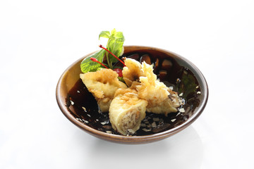 Banana in tempura. Oriental dessert isolated on white.