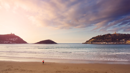 Fototapeta na wymiar Sunset on La Concha beach in San Sebastian in the Basque Country.