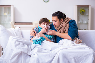 Young father caring for sick son