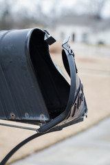 Mailbox that has been hit and damaged by car