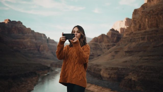 Traveler takes pictures of Grand Canyon in Arizona, river between mountains, famous natural landmark, traveling around the United States